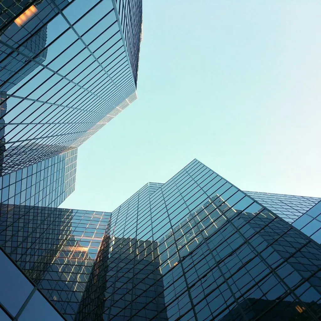 A tall building with glass windows reach for the sky.
